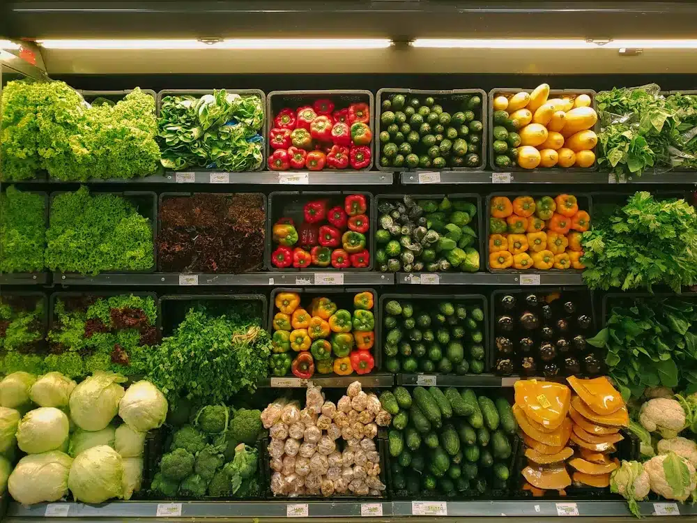 Customer pushing a trolley down a supermarket grocery aisle